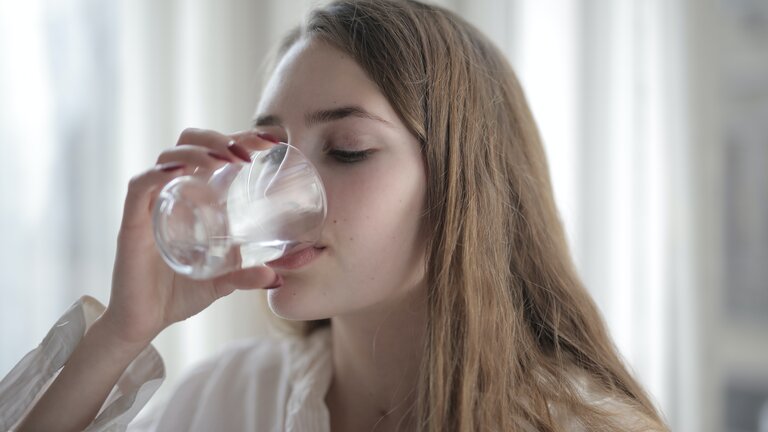 Дівчина п'є воду зі склянки | © Pexels
